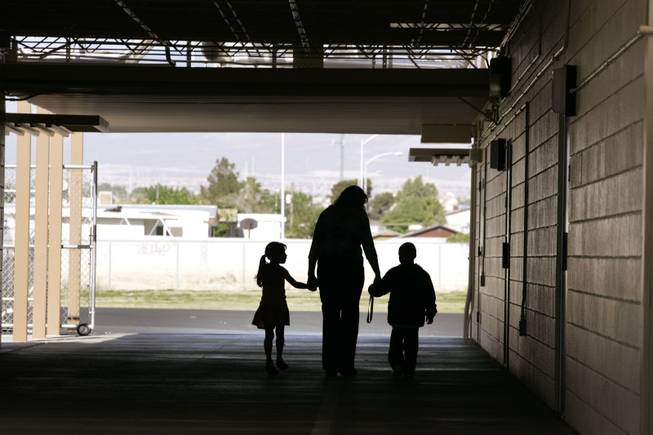 Principal Kelly Sturdy leads two first graders into the cafeteria for breakfast at Fay Herron Elementary School in North Las Vegas Monday, April 26, 2010.