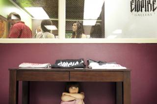 Four-year-old Isabella Villamil hides under a table outside Empire Gallery during the soft opening of Emergency Arts on Friday, May 7, in downtown Las Vegas.
