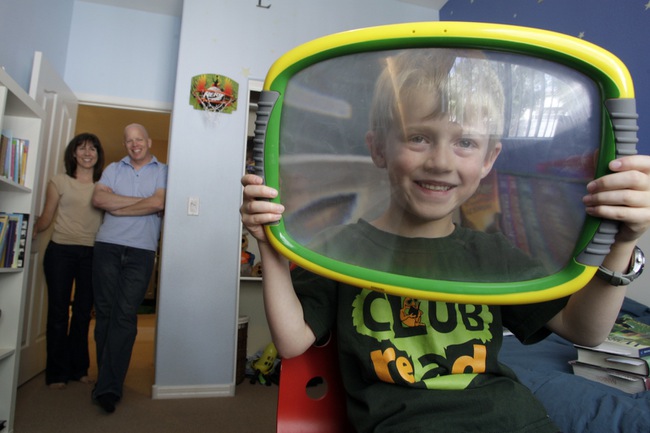 Asa Zink, 6, poses in his bedroom as his parents Marcia and Bryan look on Thursday, May 13, 2010. Asa is being homeschooled because he is profoundly gifted, and the Clark County School District doesn't offer a program to meet his needs. Plans for a stand-alone academy for gifted students have been tabled due to the budget crisis.