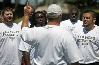 Prospective players listen as coach Don Eck gives them instruction Saturday during an open tryout for the Las Vegas Locomotives of the United Football League.