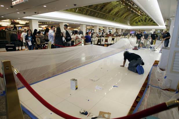 Workers install new tile around the gaming pit on the casino floor at the Tropicana Las Vegas Monday, May 17, 2010. The property is going through its first major renovation in nearly 25 years.  STEVE MARCUS / LAS VEGAS SUN .
