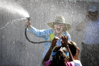 Principal Kelly Strudy sprays students with a hose during field day at Fay Herron Elementary School in North Las Vegas Thursday, May 20, 2010.