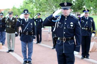 Uniformed officers salute Thursday during the annual memorial ceremony at Police Memorial Park.