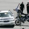 A crash test dummy flies off a motorcycle after slamming into a car during live, full-scale motor vehicle crash testing at the ARC-CSI Crash Conference at the Las Vegas Motor Speedway Monday, May 24, 2010.