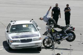 A crash test dummy flies off a motorcycle after slamming into a car during live, full-scale motor vehicle crash testing at the ARC-CSI Crash Conference at the Las Vegas Motor Speedway Monday, May 24, 2010.