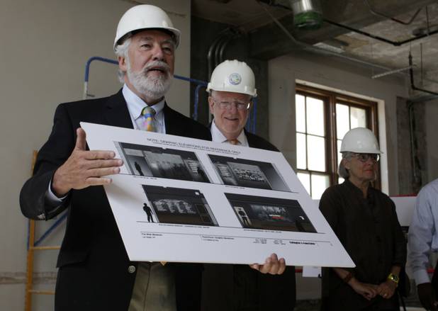 Museum designer Dennis Barrie, left, speaks during a media tour of the Las Vegas Museum of Organized Crime and Law Enforcement (the "Mob Museum") in the former U.S. Post Office and Federal Courthouse building in downtown Las Vegas Tuesday, May 25, 2010. Las Vegas Mayor Oscar Goodman, center, looks on. Dennis' wife and co-designer Kathleen Barrie is at far right.