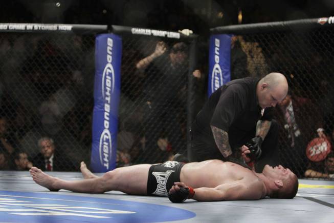 An official checks on heavyweight fighter Todd Duffee of Las Vegas after he is knocked out by Mike Russow of Illinois during UFC 114 on Saturday at the MGM Grand Garden Arena.