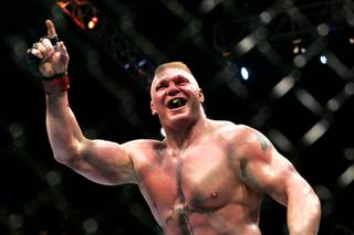 Brock Lesnar points to the stands after submitting Shane Carwin in the second round of their heavyweight title fight Saturday, July 3, 2010, at UFC 116. Lesnar won with a second-round submission.