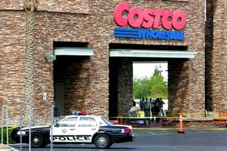 Metro crime scene investigators, officers and detectives mill about the entrance of the Costco store in Summerlin after the shooting July 10, 2010.