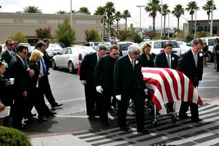 The body of former Governor Kenny Guinn is carried into St. Joseph, Husband of Mary Roman Catholic Church before the start of funeral services, Tuesday, July 27, 2010. Guinn passed away last Thursday while working on the roof of his Las Vegas home.