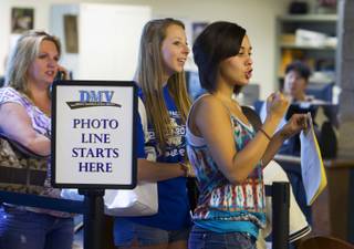 Jordan Medina, right, celebrates as she gets to the front of the photo line at the Department of Motor Vehicles office in Henderson Monday, August 2, 2010. School officials on Wednesday will consider a policy that would prohibit students from getting driver's licenses if they cut classes.