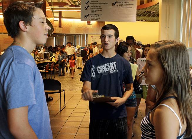 Foothill High School students Shane Marshall, left, and Tyler Hauger, chat as they wait in a line at the Department of Motor Vehicles office in Henderson Monday, August 2, 2010. School officials on Wednesday will consider a policy that would prohibit students from getting driver's licenses if they cut classes.
