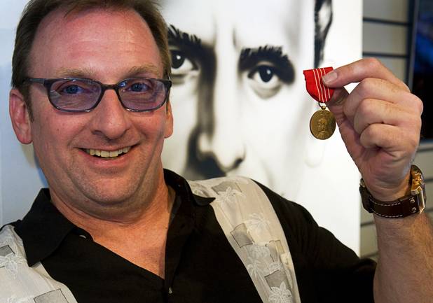 Meyer Lansky II, grandson of organized crime figure Meyer Lansky, holds up  his father's Medal of Freedom during a news conference at the Las Vegas Mob Experience preview center at the Tropicana Monday, August 2, 2010. The medal was given to his grandfather by President Harry Truman for his assistance during World War II, Lansky said.