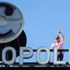 CEO John Unwin waves to spectators on the CityCenter bridge from atop the Cosmopolitan of Las Vegas marquee.