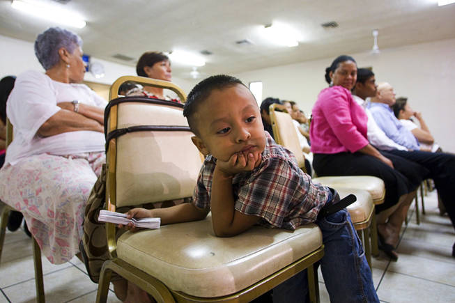 Daniel Martinez, 3, waits during an immigration vigil at Amistad Cristiana, an interdenominational church on Stewart Avenue, Thursday, August 5, 2010. The boy's father was one of the musicians. Pastor Joel Menchaca said he called the vigil because many people were fearful after a series of immigration raids last week. 