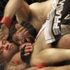 Jon Fitch, top, punches Thiago Alves at UFC 117 on Saturday in Oakland, Calif.. Fitch won by unanimous decision.