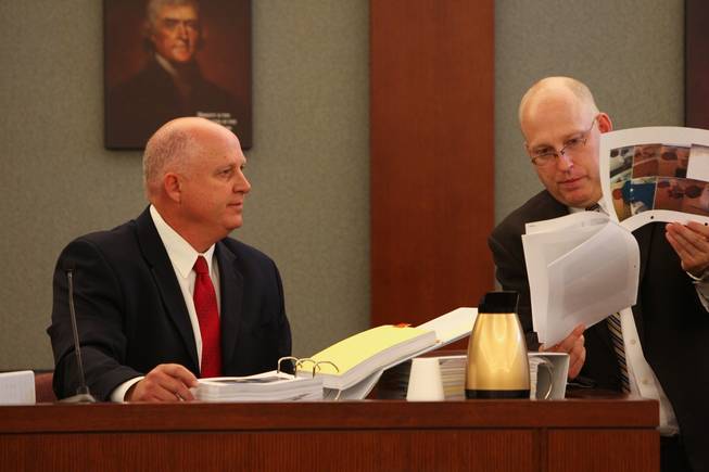 Detective Dan Long, with the aid of Chief Deputy District Attorney Christopher Laurent, right, reviews photos of marijuana from the cell phone of Trevon Cole while testifying Saturday during a coroner's inquest at the Regional Justice Center. 