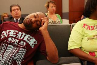 Craig Smith sinks into his chair and closes his eyes after hearing the shooting of Trevon Cole was justified during a coroner's inquest Saturday, August 21, at the Regional Justice Center. 
