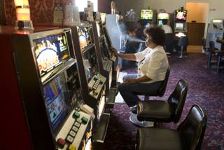 Yolanda Mua'e plays slots in the Cal-Nev-Ari Casino Thursday, Sept. 2, 2010. The community, started by California pilots Nancy and Slim Kidwell in the 1960s, is up for sale  for $17 million. 