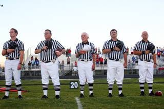 The referees put their hands over their heart just before Palo Verde and Liberty face off Friday. Palo Verde edged out a 24-21 victory.