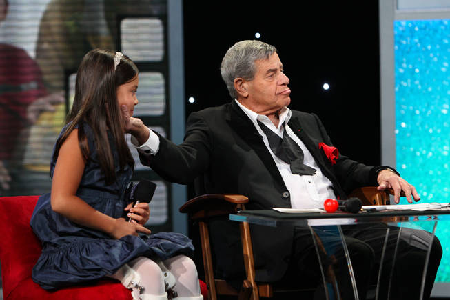 After sharing "I love yous," Jerry Lewis fondly touches Abbey Umali's face Monday afternoon during the final hour of the 45th Annual Jerry Lewis MDA Labor Day Telethon at the South Point. Umali is the 2010 MDA youth ambassador.
