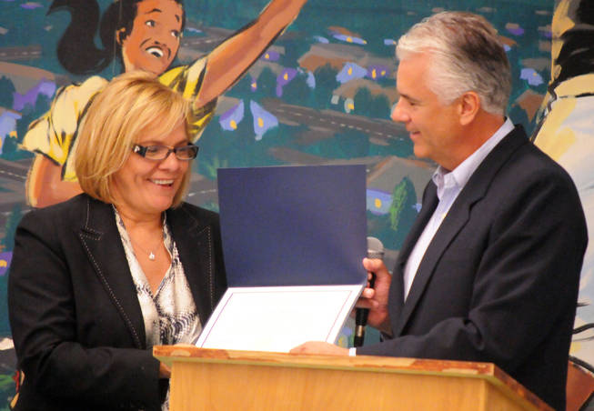 Sen. John Ensign (R-Nev.) awards Halle Hewetson Elementary School Principal Lucy Keaton a certificate that names her Nevada's most distinguished elementary school principal by the National Association of Elementary School Principals. 