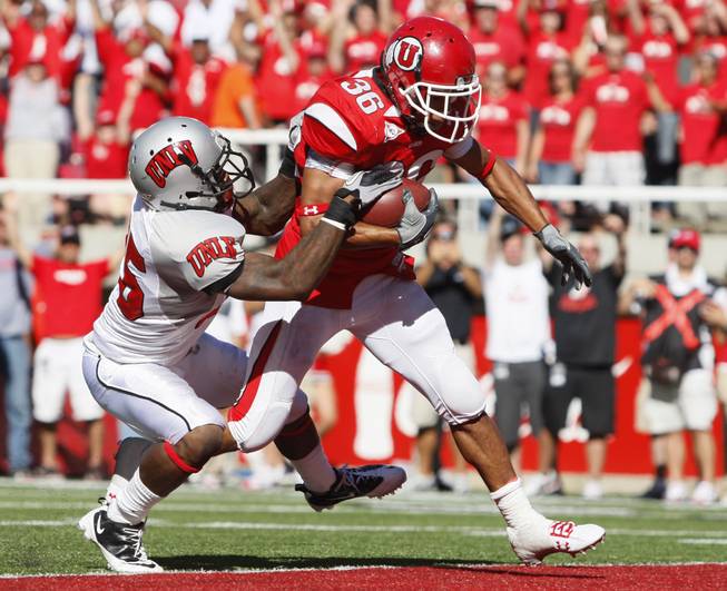 UNLV safety Mike Grant (25) is unable to stop Utah running back Eddie Wide (36) as he scores a touchdown in the 4th quarter of an NCAA college football game at Rice-Eccles Stadium, Saturday, Sept. 11, 2010, in Salt Lake City, Utah.  Utah defeated UNLV 38-10.