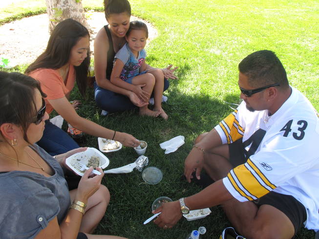 Family members (from left to right) Michelle Oliv&eacute;, Kristen Uy, 16, Mariah Oliv&eacute;, 15, Masina Oliv&eacute;, 5, and Tau Oliv&eacute; enjoy a picnic of Hawaiian food at the Prince Jonah Ho'olaule'a Pacific Islands Festival in Henderson on Sunday. The family has been coming to the festival for several years.