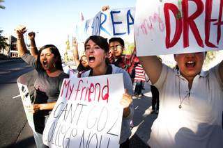 Adelia Vazquez, center, 17, a senior at Desert Pines High School, cheers during a rally Tuesday in downtown Las Vegas to support the DREAM Act.