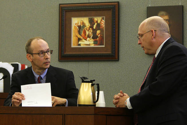 Dr. Joseph Gnoyski, left, one of Erik Scott's physicians, listens to Chief Deputy District Attorney Christopher Laurent during a coroner's inquest at the Regional Justice Center Wednesday, September 22, 2010. 