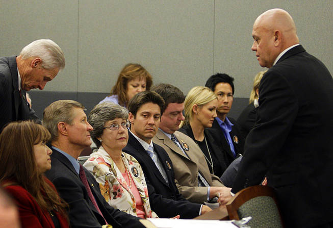 Members of the Scott family, father Bill, mother Linda, and younger brother Kevin, listen to Clark County Coroner Mike Murphy before a coroner's inquest at the Regional Justice Center September 22, 2010. 
