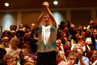 A supporter of Senator Harry Reid applauds after Reid's taped remarks during a Senate candidate forum for Reid and Sharron Angle at Faith Lutheran High School Thursday, September 23, 2010.
