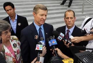 Bill Scott, center, father of Erik Scott, speaks to reporters after a coroner's inquest for Erik Scott at the Regional Justice Center Tuesday, September 28, 2010. With Bill Scott are his wife Linda and attorney Ross Goodman. The jury found that the shooting of Erik Scott was justified. 