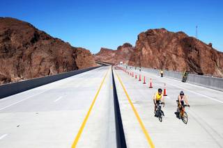 Participants in the Viva Bike Vegas event gather Saturday on the Hoover Dam bypass bridge before turning around to finish their 115-mile ride.