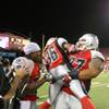 Photo: Locos cornerback Isaiah Trufant (36) is hoisted in