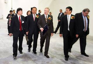 Senate Majority leader Harry Reid, center, arrives with Kai Huang, 2nd left, deputy mayor of Shenyang, China, Jinxiang Lu, 2nd right, chairman/CEO of A-Power, and Tom Conway, right, international vice president of the United Steelworkers union, for the dedication of a new A-Power Energy Generation Systems manufacturing facility in Henderson Tuesday, October 12, 2010. A translator is at far left. The company, based in China, will produce wind turbines and LED lighting.