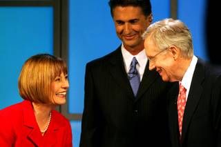 Sharron Angle and Sen. Harry Reid exchange pleasantries after their debate, moderated by Mitch Fox, center, on Thursday at the Vegas PBS studios.