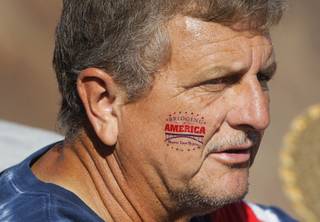 Scott Lester wears a temporary tattoo on his cheek at the new Mike O'Callaghan-Pat Tillman Memorial Bridge during the Bridging America event Saturday, October 16, 2010. About 15,000 people were expected to attend.
