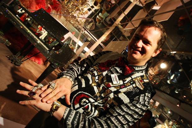 Employee Stephen Mathis shows off his love for bling while working the final day at the Liberace Museum after 31 years of operation in Las Vegas.