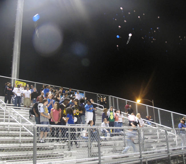 Students release balloons before Thursday night's football game between Eldorado High School and Rancho High School in memory of teachers Timothy VanDerbosch and Pamela Orr-Sowers. VanDerbosch was killed Wednesday morning at University Medical Center after being robbed, beaten and accidentally run over near Washington Avenue and Betty Lane.