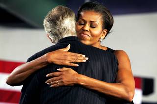 Sen. Harry Reid and First Lady Michelle Obama greet each other during a rally at Canyon Springs High School in North Las Vegas Monday, November 1, 2010.