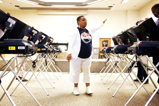 Poll worker Ernestine Terrell directs voters to their stations during Election Day at the West Las Vegas Library in Las Vegas Tuesday, November 2, 2010.