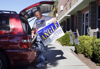 A volunteer loads campaign signs into a vehicle at the West Sahara Avenue campaign headquarters of Republican challenger Sharron Angle on Tuesday, Nov. 2, 2010. The signs will be used for the election night party at the Venetian, he said. 