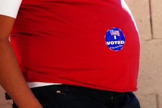 A voter displays her I Voted sticker on her pregnant belly outside of her polling station in Henderson Tuesday, November 2, 2010.