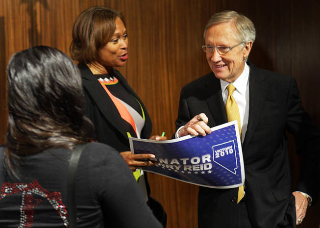 Senate Majority Leader Harry Reid, right, speaks with supporters after a news conference at Vdara Wednesday, November 3, 2010.