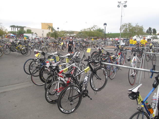 Volunteers at the Nevada Silverman Triathlon help athletes store their bikes after they finish the biking portion of the race. The full-distance triathlon included a 2.4-mile swim at Lake Las Vegas, a 112-mile bike ride and a 26.2-mile run in Henderson on Sunday,
