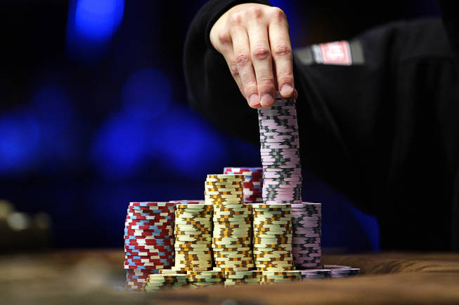 Jonathan Duhamel stacks his chips as he plays against John Racener during the World Series of Poker Main Event at the Rio on Monday, November 8, 2010.