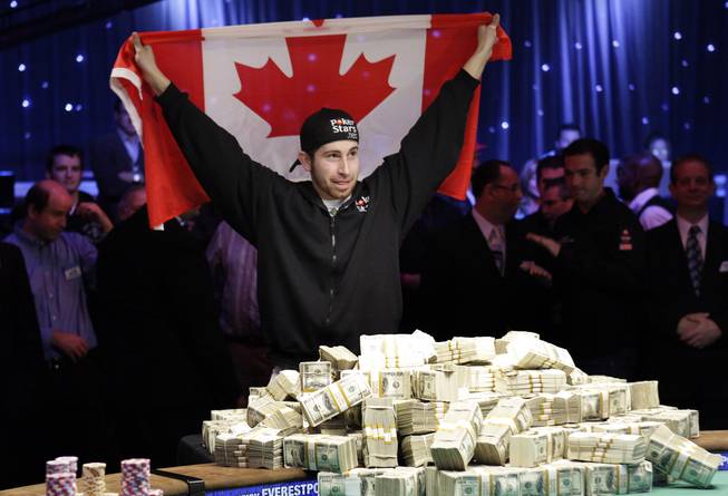 Jonathan Duhamel of Canada holds up a Canadian flag after beating John Racener in the finals of the World Series of Poker Main Event at the Rio on Monday, November 8, 2010. Duhamel won the championship bracelet and $8.9 million in prize money. 
