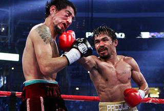 Manny Pacquiao, right, of the Philippines connects on Antonio Margarito during their WBC super welterweight title fight at Cowboys Stadium in Arlington,Texas Saturday, November 13, 2010. Pacquiao won the 12-round fight by unanimous decision.