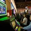Steven Drewes and Cassie Mayfield, of the Downstream Casino Resort in Oklahoma, try out a IGT Ghostbusters-themed video slot machine during the Global Gaming Expo (G2E) at the Las Vegas Convention Center Tuesday, November 16, 2010. 